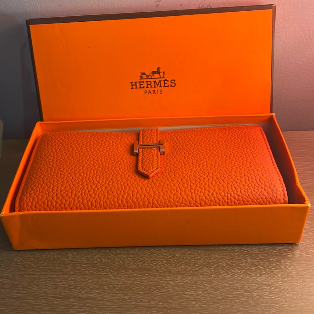 Orange wallet brand new never used has a gold accent on the front